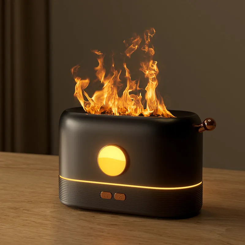 Black USB humidifier with simulation flame light effect and water mist output on a wooden desk.