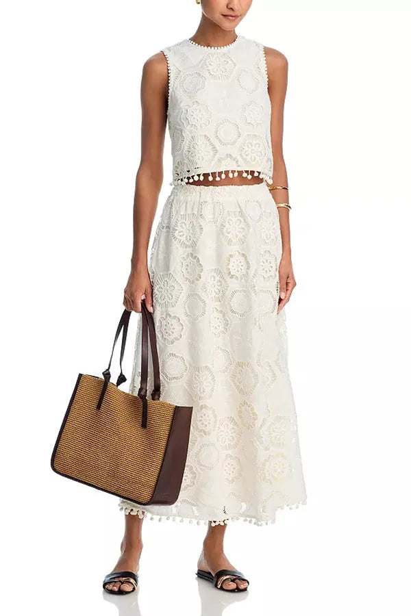 Literary Trends white women's suit set with sleeveless top and embroidered long skirt on a hanger.