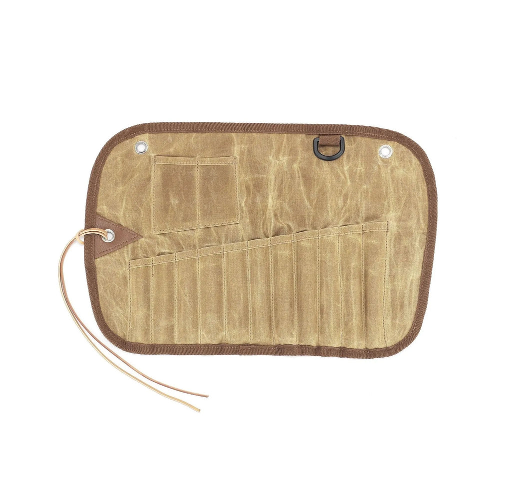 Green waxed canvas storage bag containing a wooden handle cutlery set for outdoor use.