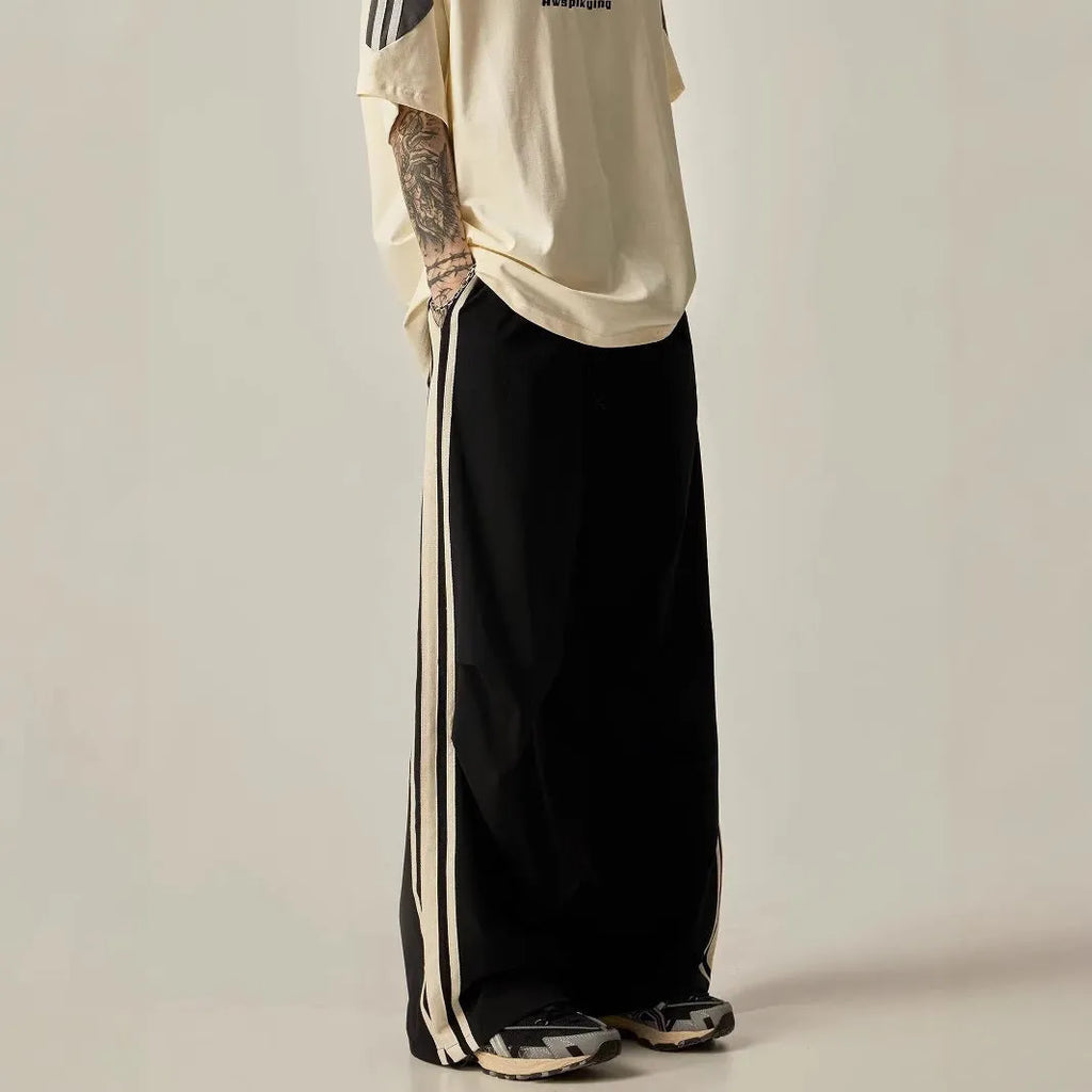 Black wide-leg men's climbing trousers with a high waist on a neutral background.