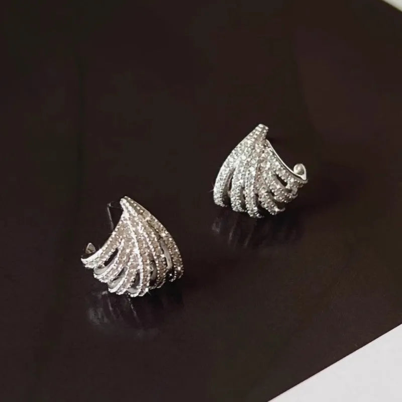 A pair of geometric zircon earrings with a line design and platinum electroplated finish.