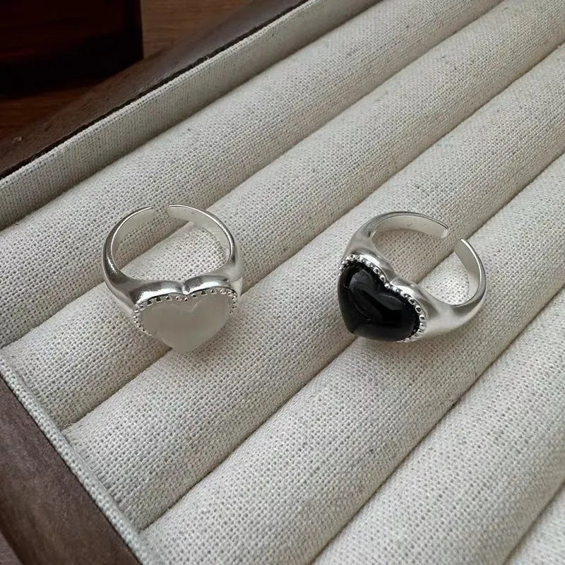 Sterling silver adjustable ring with black agate heart centrepiece on finger