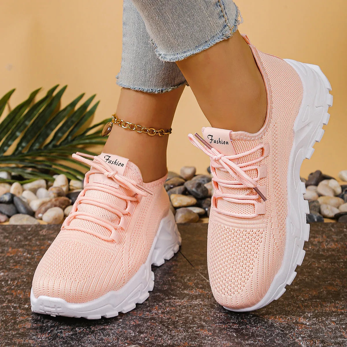 Women's low-top mesh sports shoes in a flyknit style with a round toe and front lace-up closure.
