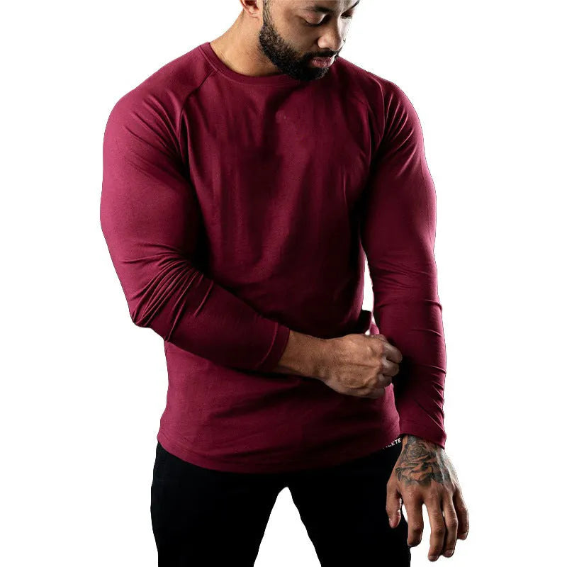 Men's tight-fitting long sleeve cotton sports T-shirt in grey, worn for gym training.