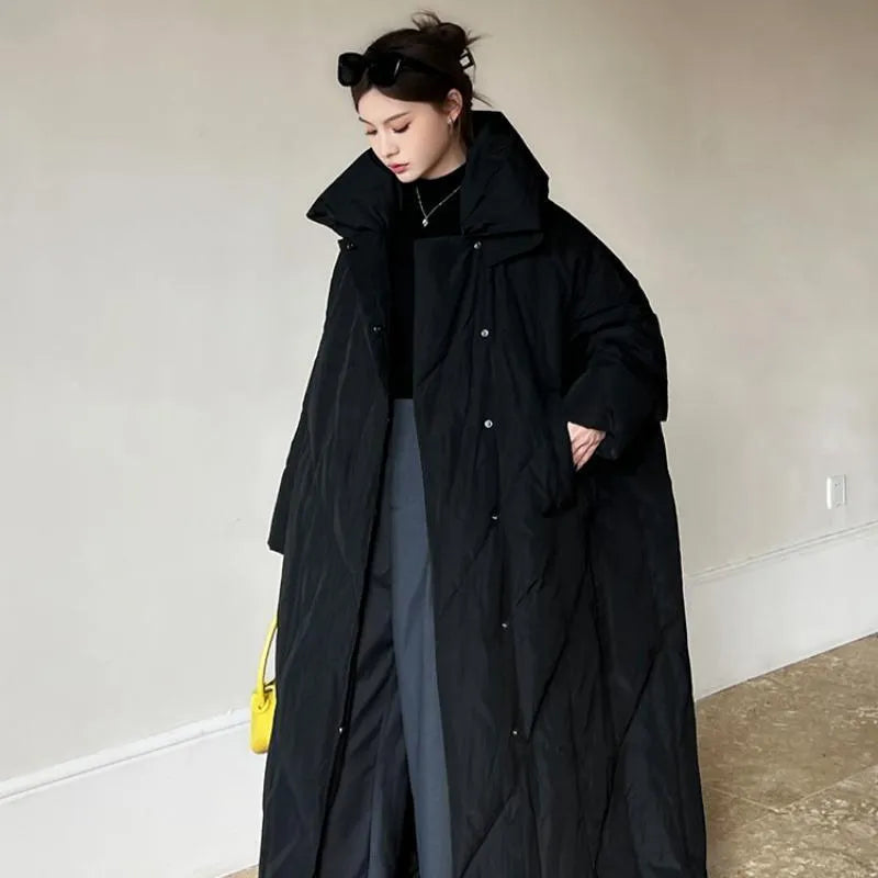 Women's large size mid-length loose fit winter coat with front zipper in black on a model