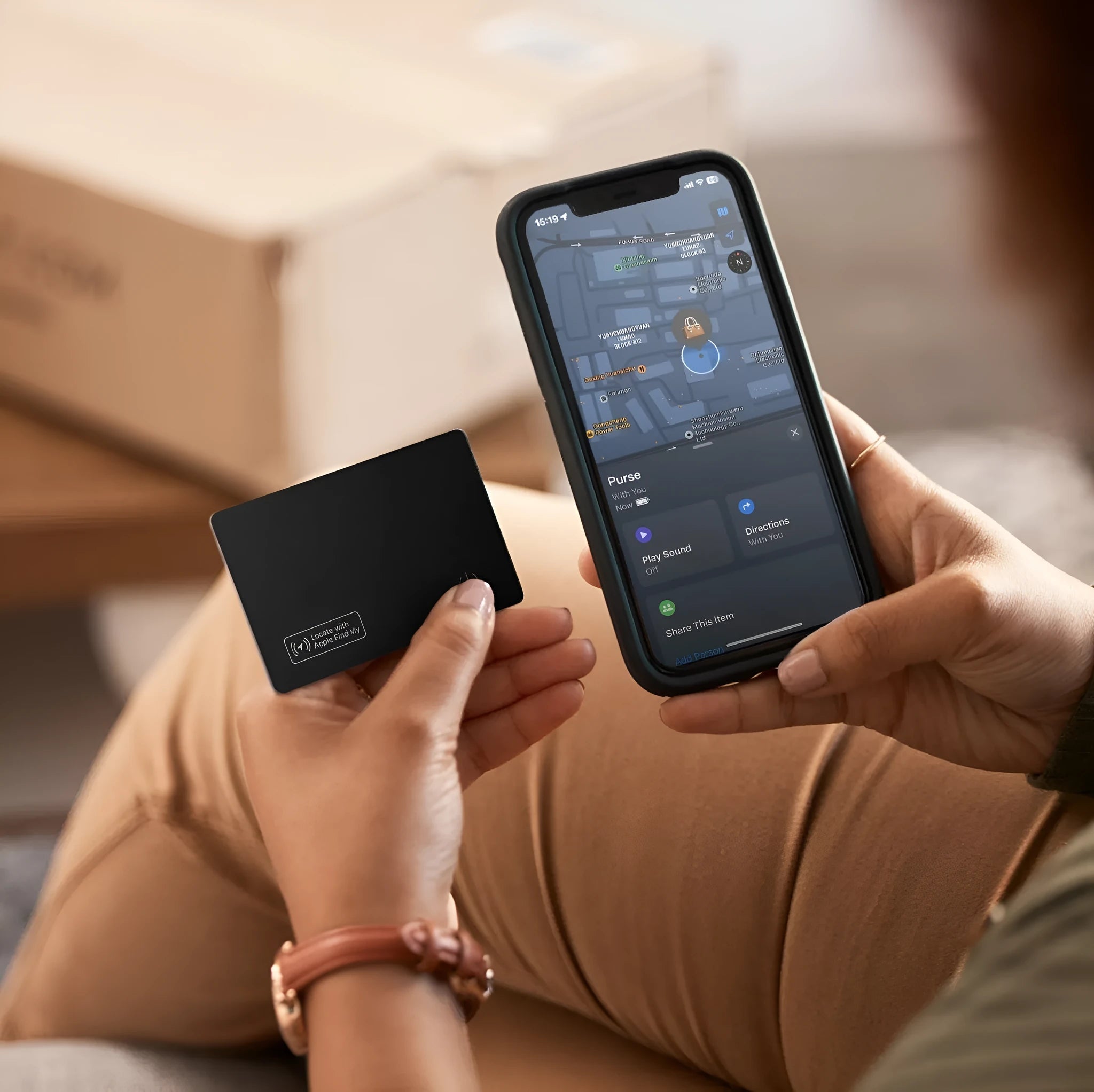 Black ultra-thin anti-loss card for Apple devices, shown next to a credit card for size comparison.