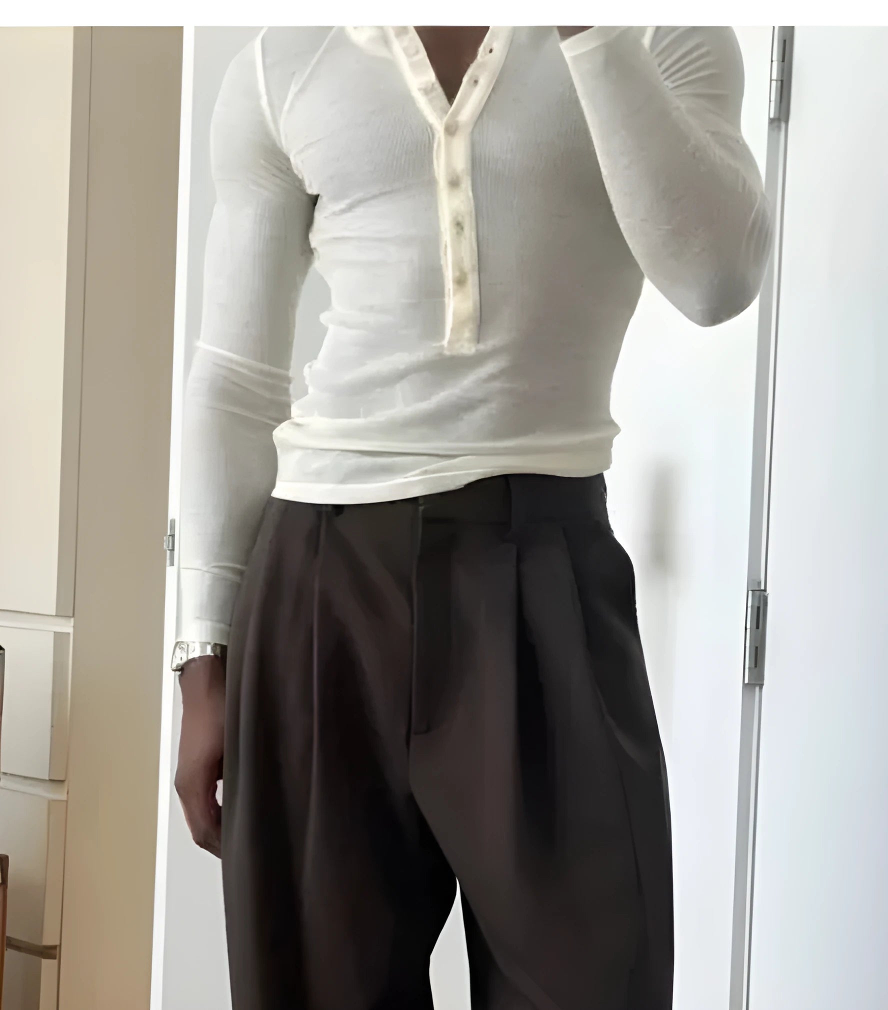Men's cream coloured ribbed long sleeve Henley top with button placket on a mannequin.