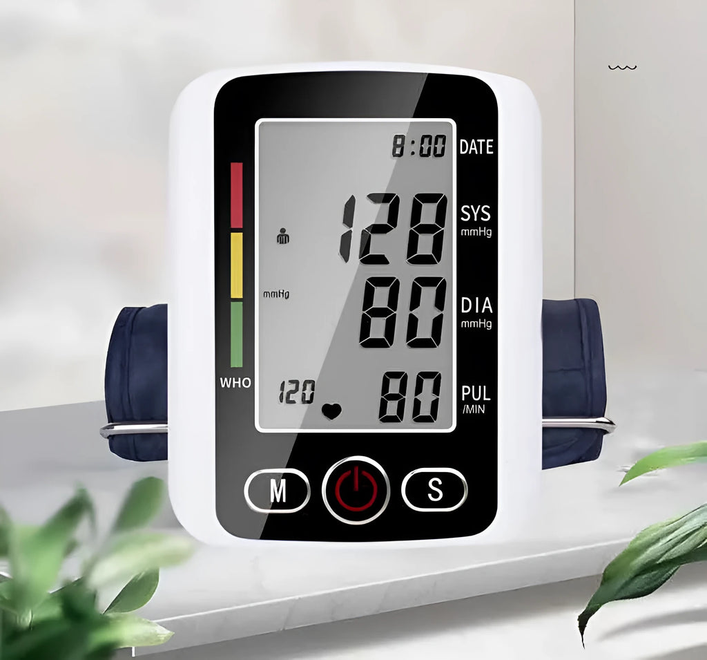 Automatic arm blood pressure monitor on a table with large screen and arm cuff.