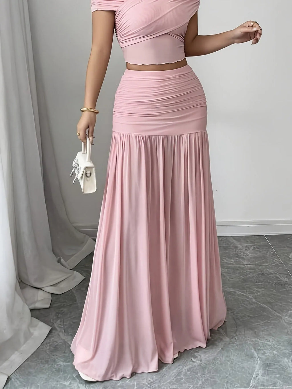 Women's pleated long skirt in polyester with irregular hem available in pink and beige sizes S to XXL