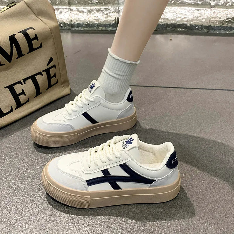 Brown and blue low-top casual lace-up shoes with a round toe and flat rubber sole.
