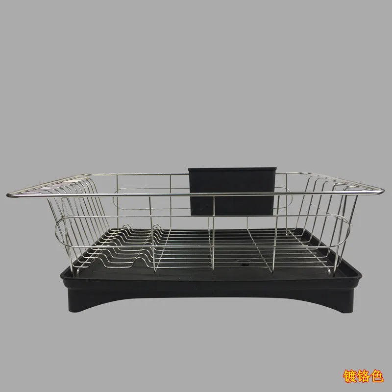Black stainless steel dish drying rack with cutlery holder and drainboard on a kitchen counter.