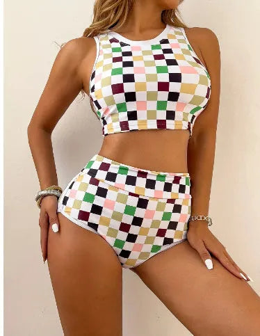 Women's backless one-piece swimsuit with black and white chessboard pattern and sporty suspender straps.