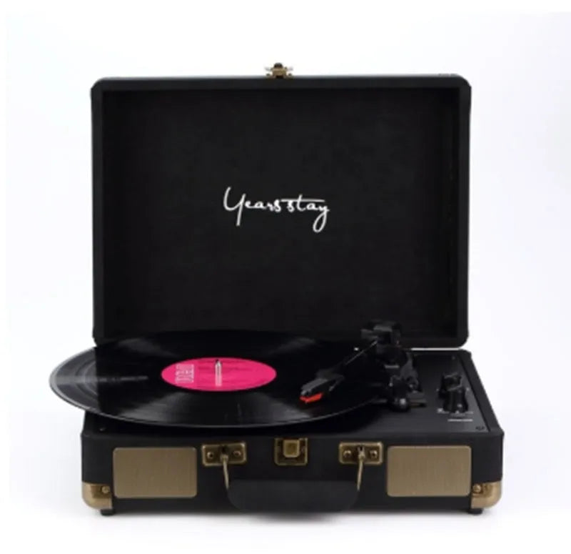 Portable Bluetooth record player in a leather-textured suitcase case, shown in a selection of colours.