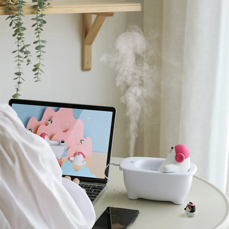 White USB desktop air humidifier with large water tank showing mist output.