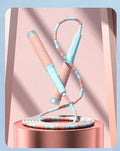 Children's skipping rope with soft blue bead handles and a non-knotted beaded cord.