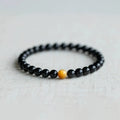 Black obsidian stone bracelet with geometric beads in Korean unisex style.