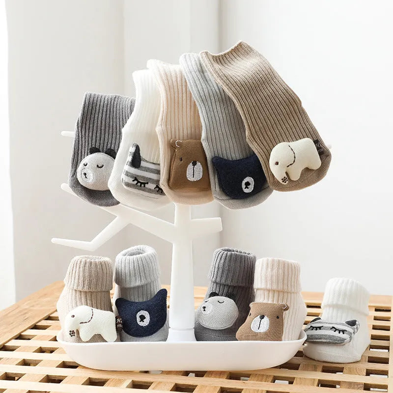 Pair of light grey baby socks with white non-slip silicone grip dots on the soles.