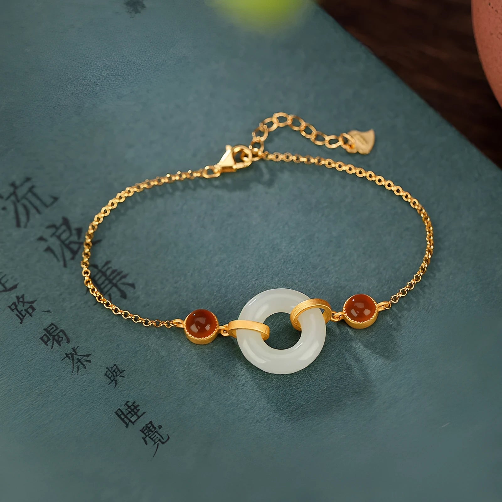 Gold plated S925 sterling silver bracelet with an inlaid natural Hetian jade peace buckle charm.