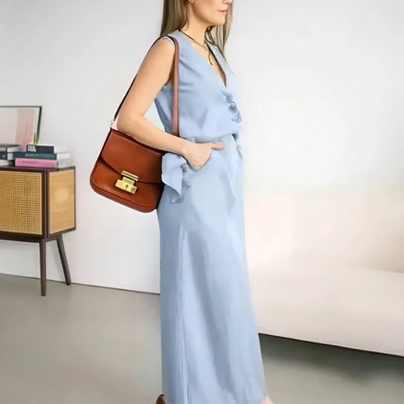 Women's blue casual two-piece suit with sleeveless vest and long skirt on a hanger.