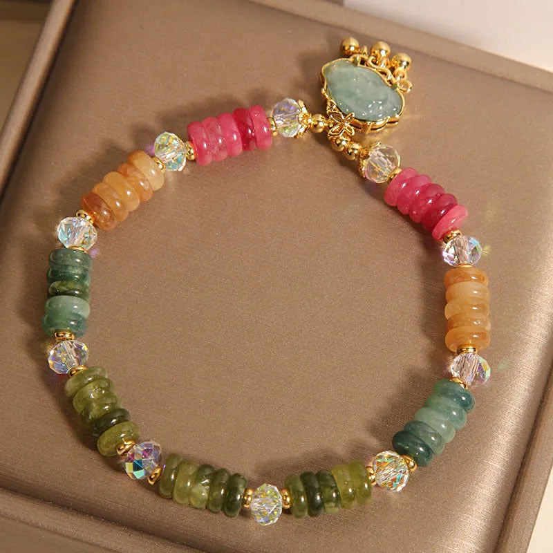 Colorful Tourmaline Jade Xiangyun crystal bracelet with alloy inlay and stone accents on display