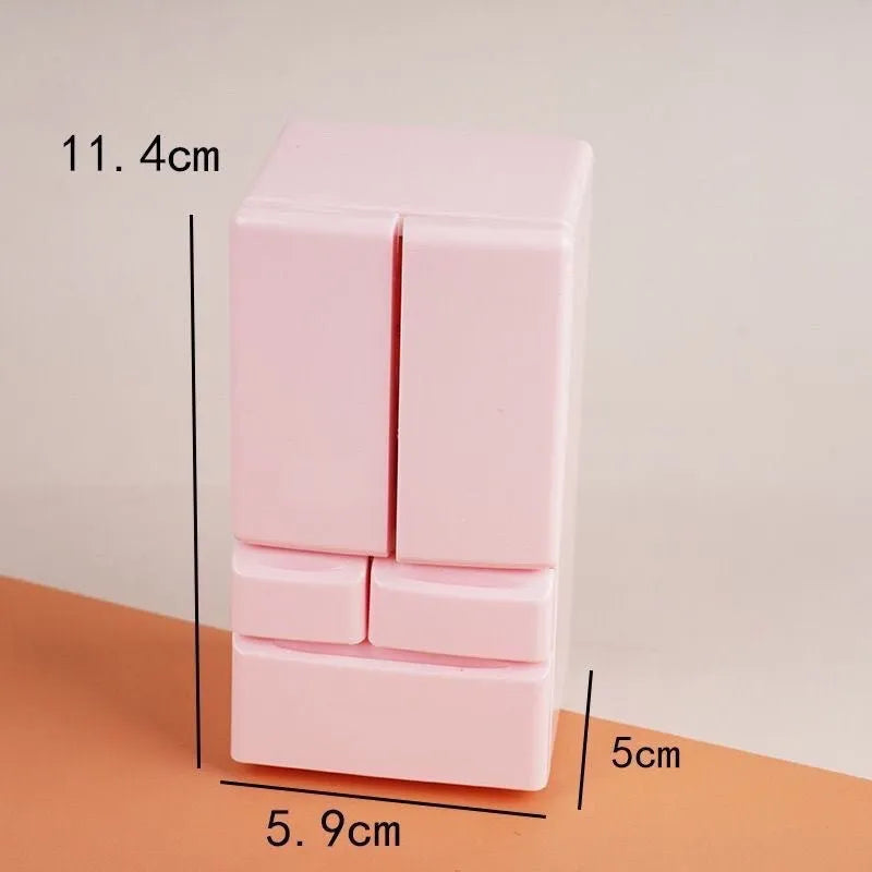 White plastic miniature candy shop model with internal light turned on, showing detailed interior.