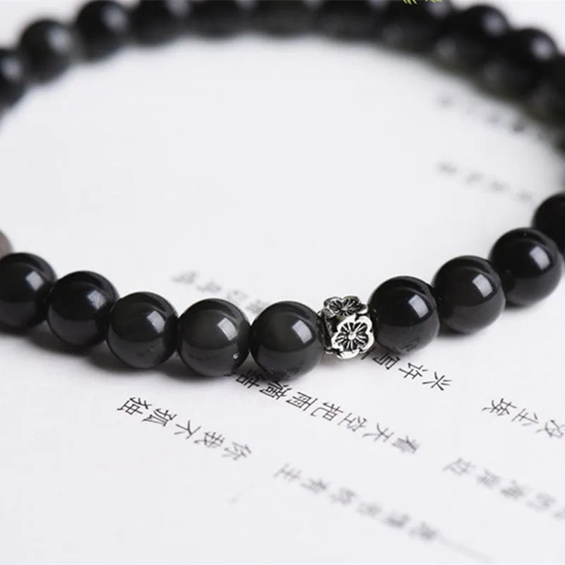 Natural black obsidian bracelet with S925 sterling silver flower charm and dragon phoenix decorations on wrist