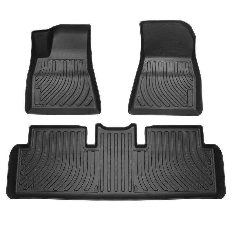 Rubber and TPE floor mat set for a Tesla car interior.