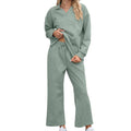 Women's solid colour knitted lapel sweater and cropped pants suit set on a hanger.