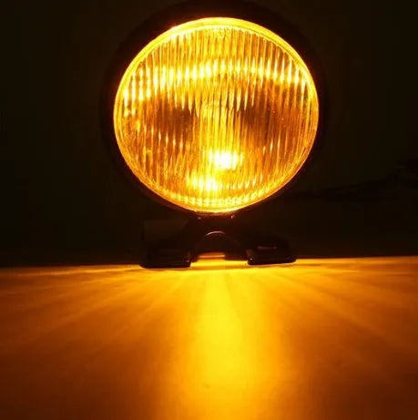 Round bottom mount motorcycle headlight with black aluminium shell, amber glass lens, 12.5 x 8.5 cm, front placement