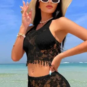 Women's white lace-up bikini set with matching tassel skirt for beach wear