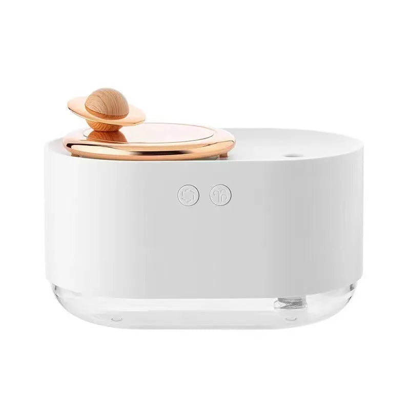 Green rotating planet humidifier with USB charging port and night light on white surface