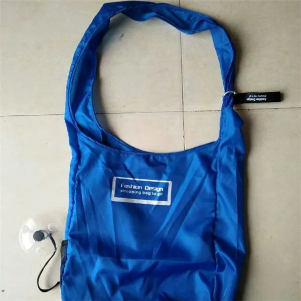 Disc folding portable shopping bag in red unfolded showing 33x40x10cm size with compact 10.5cm disc beside it