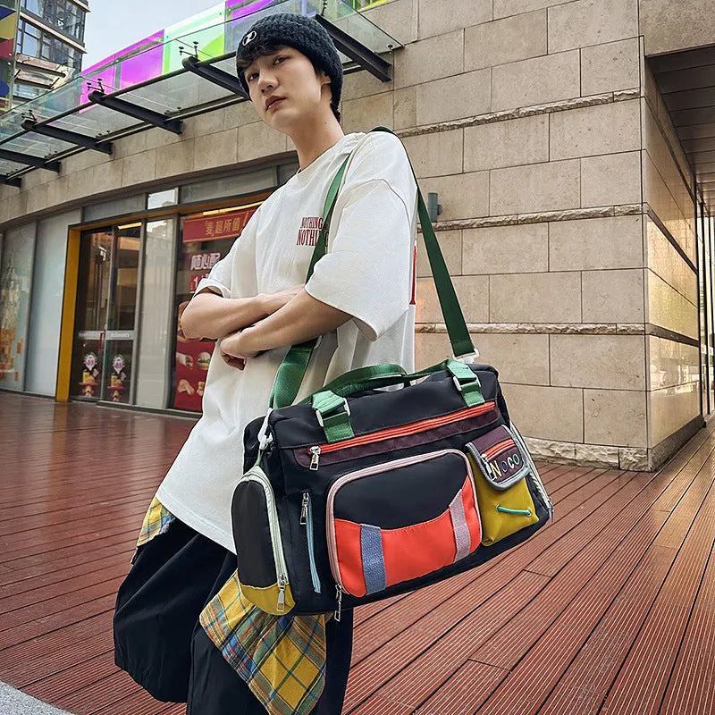 Large black sports shoulder messenger bag with shoulder strap showing exterior dimensions