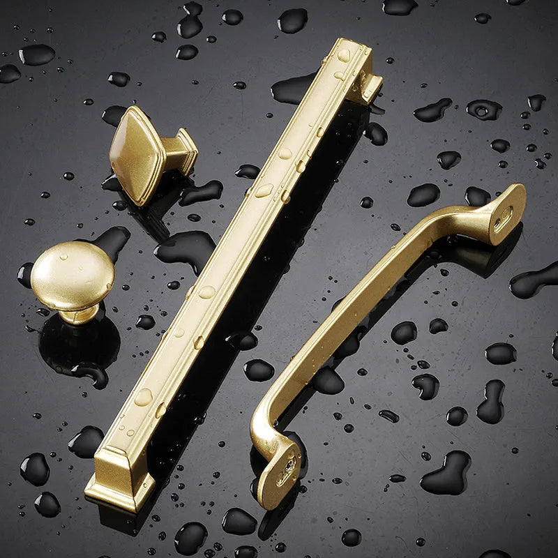 Gold aluminium alloy single-hole cabinet handle in a modern T-shape design.