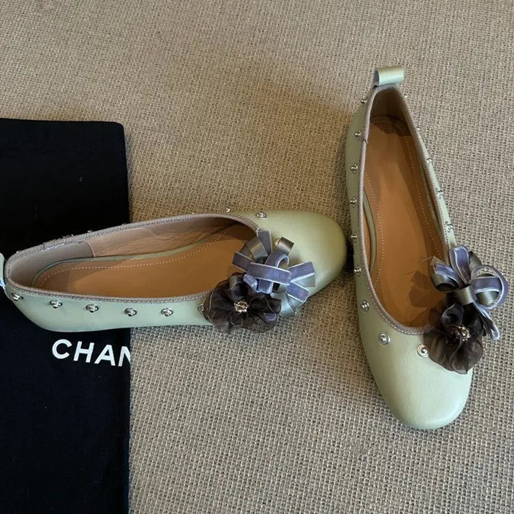 Silver Mary Jane buckle flats with DIY flower rivets on the strap, showing round toe and low top profile.