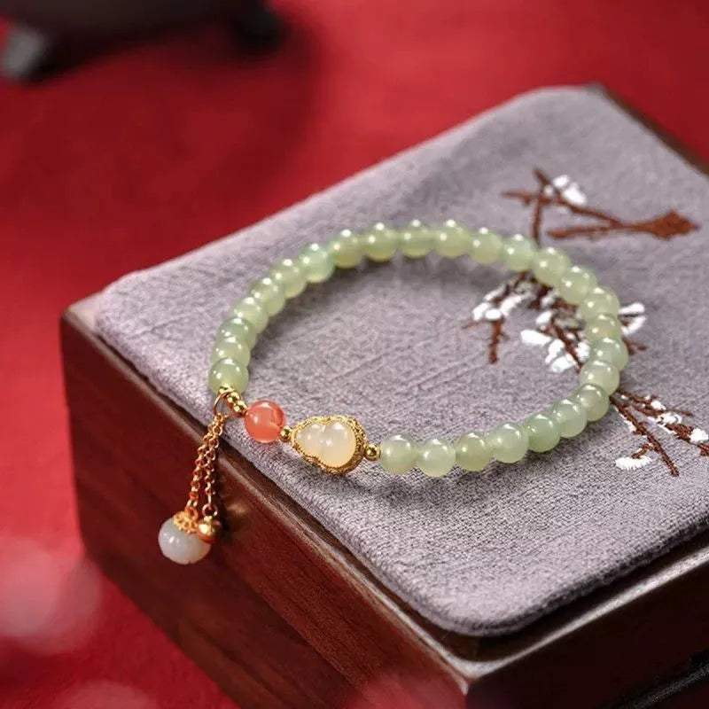 Jade and gold plated women's bracelet with fu character charm and Chinese knot fastening