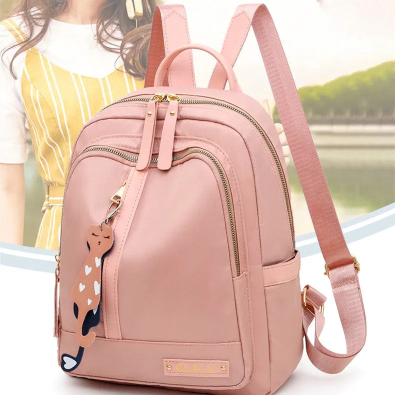 A black soft nylon women's casual travel backpack with double straps and multiple internal compartments.