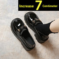 Black leather slip-on shoes with chunky square heel, round toe, and skull pattern design.