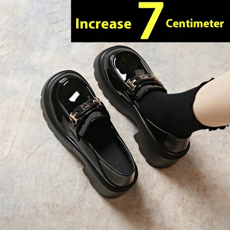 Black leather slip-on shoes with chunky square heel, round toe, and skull pattern design.