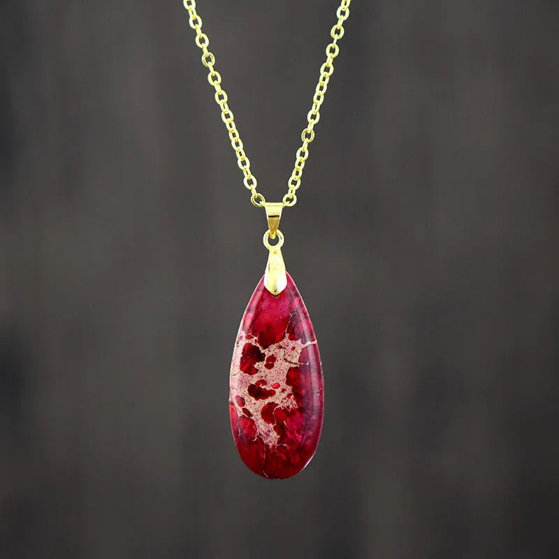 Emperor Stone jade pendant necklace on a gold chain, showing hand-carved detail and a lobster clasp.
