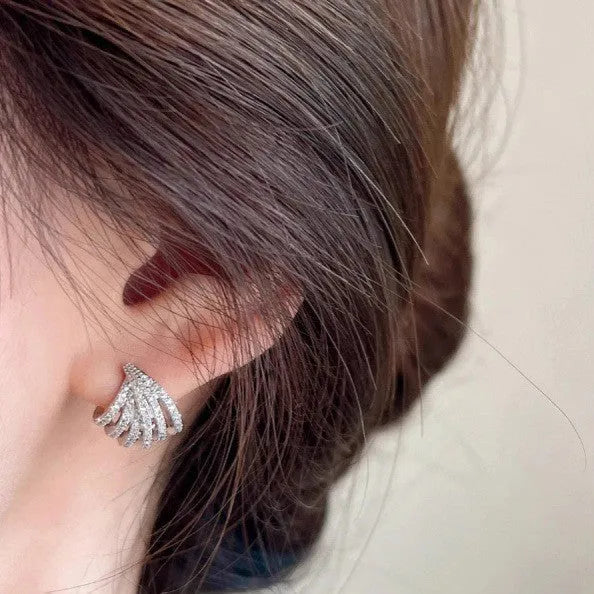 A pair of geometric zircon earrings with a line design and platinum electroplated finish.