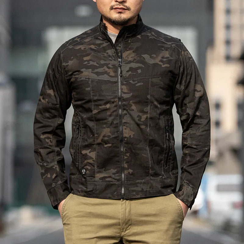 Man wearing a brown plaid pattern Outdoor Tactics Coat Assassin Jacket with a camouflage design on the pockets.