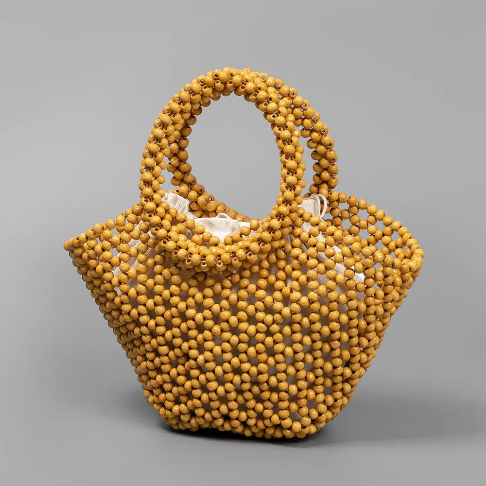 Hand-woven maple wood hollow handbag with wooden bead decoration in dumpling shape