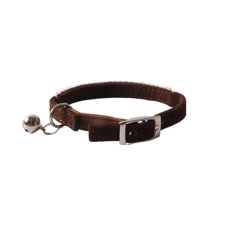 Soft pink flocked cat collar with a plastic buckle on a 28cm elastic band, showing gang drill holes for tags.