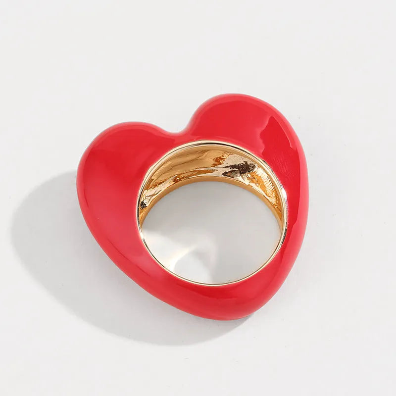 Original three-dimensional enamel heart ring in zinc alloy, shown in black, pink, purple, or red.