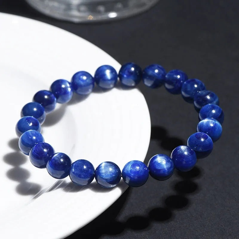 Polished blue geometric crystal bracelet with Ruyi design elements on a wrist.