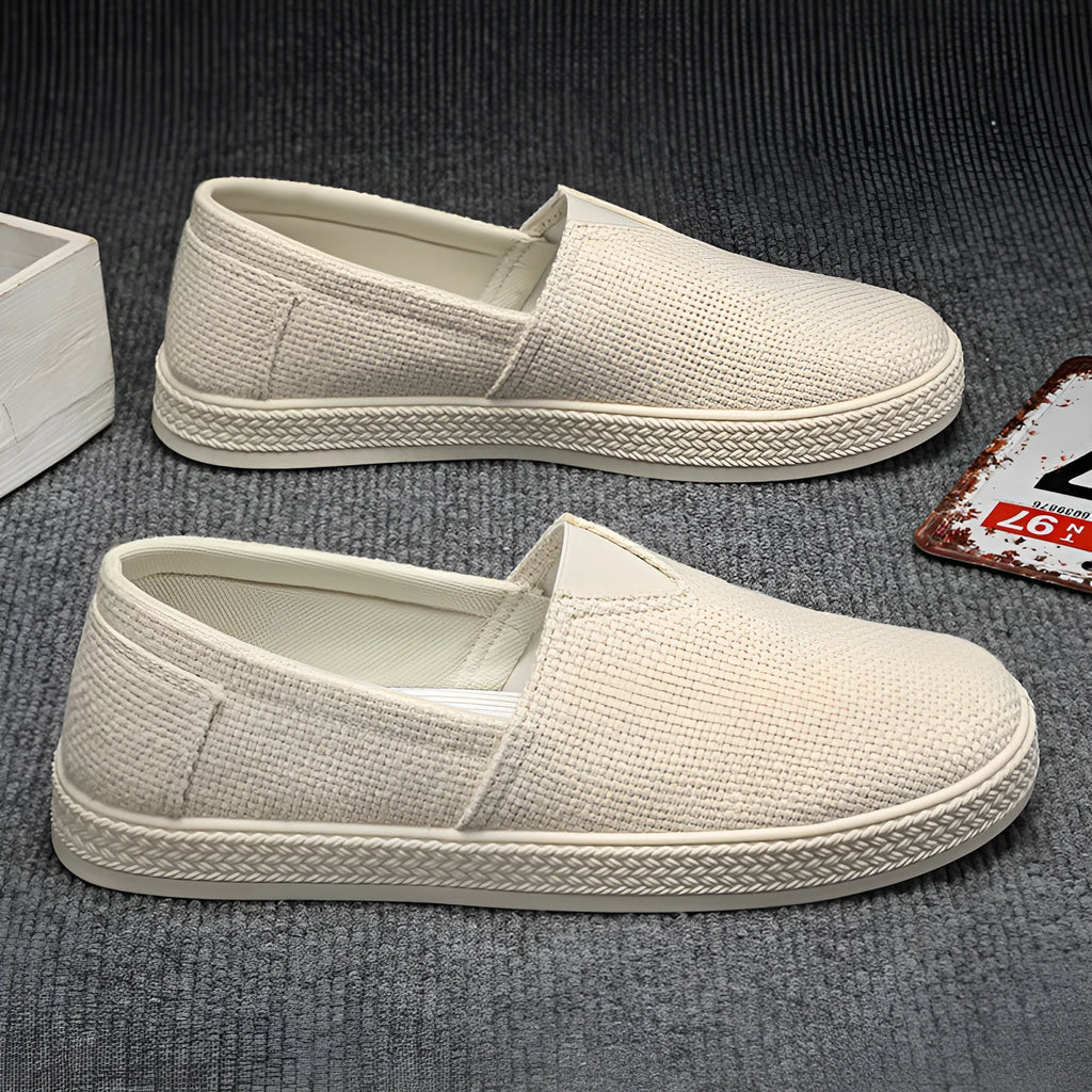 Men's beige canvas casual shoes with round toe and shallow cut, shown on a white background.