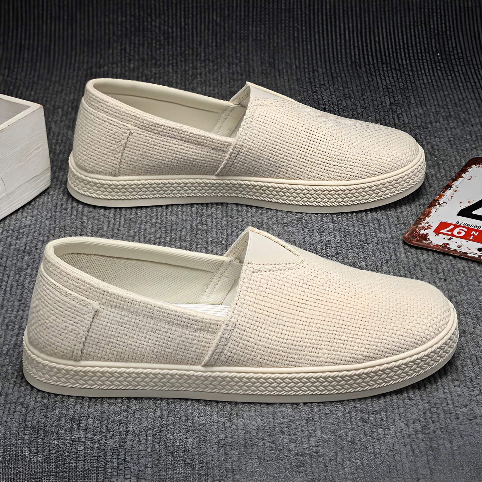 Men's beige canvas casual shoes with round toe and shallow cut, shown on a white background.