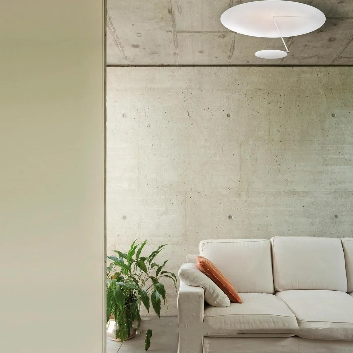 Modern round iron ceiling lamp with a white finish, mounted flush against a ceiling.