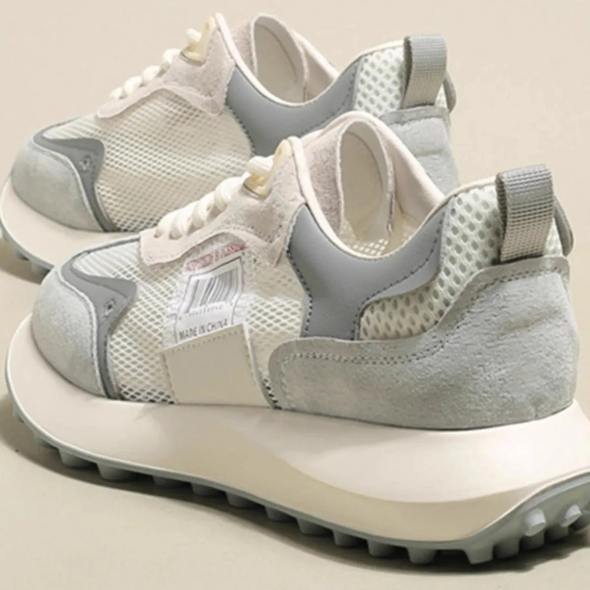 Women's grey and pink retro sneaker with low-top design and round toe